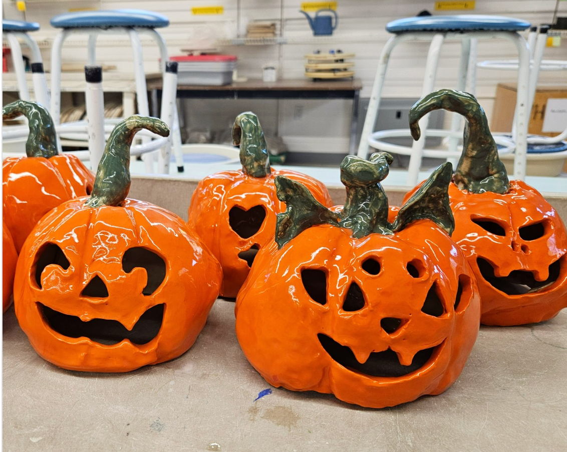 Glazed ceramic jack-o'-lanterns from Claya's Handbuild a Pumpkin Night in RiNo, Denver