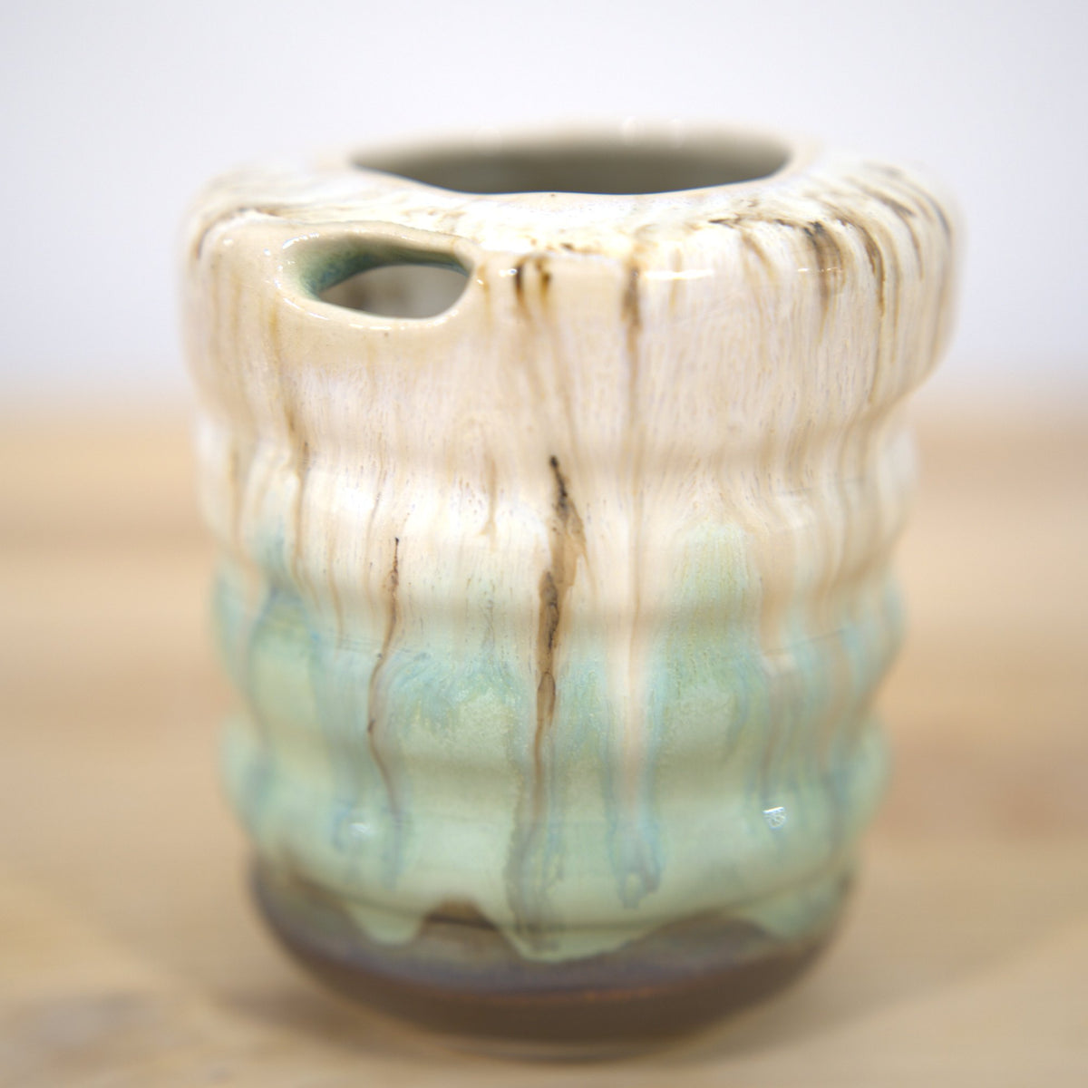 Ribbed vase with drippy white and celadon glaze made at Claya Studios in RiNo, Denver