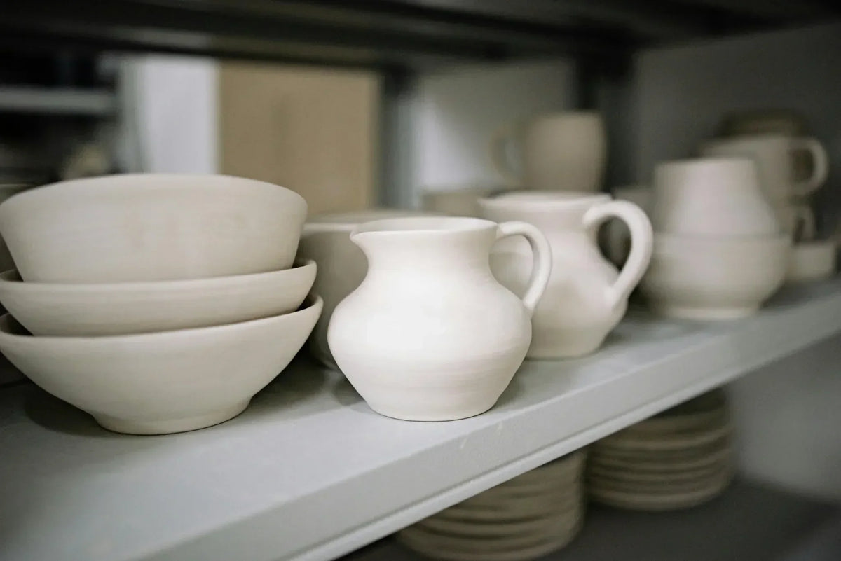 Finished student mugs and bowls from a Claya wheel class