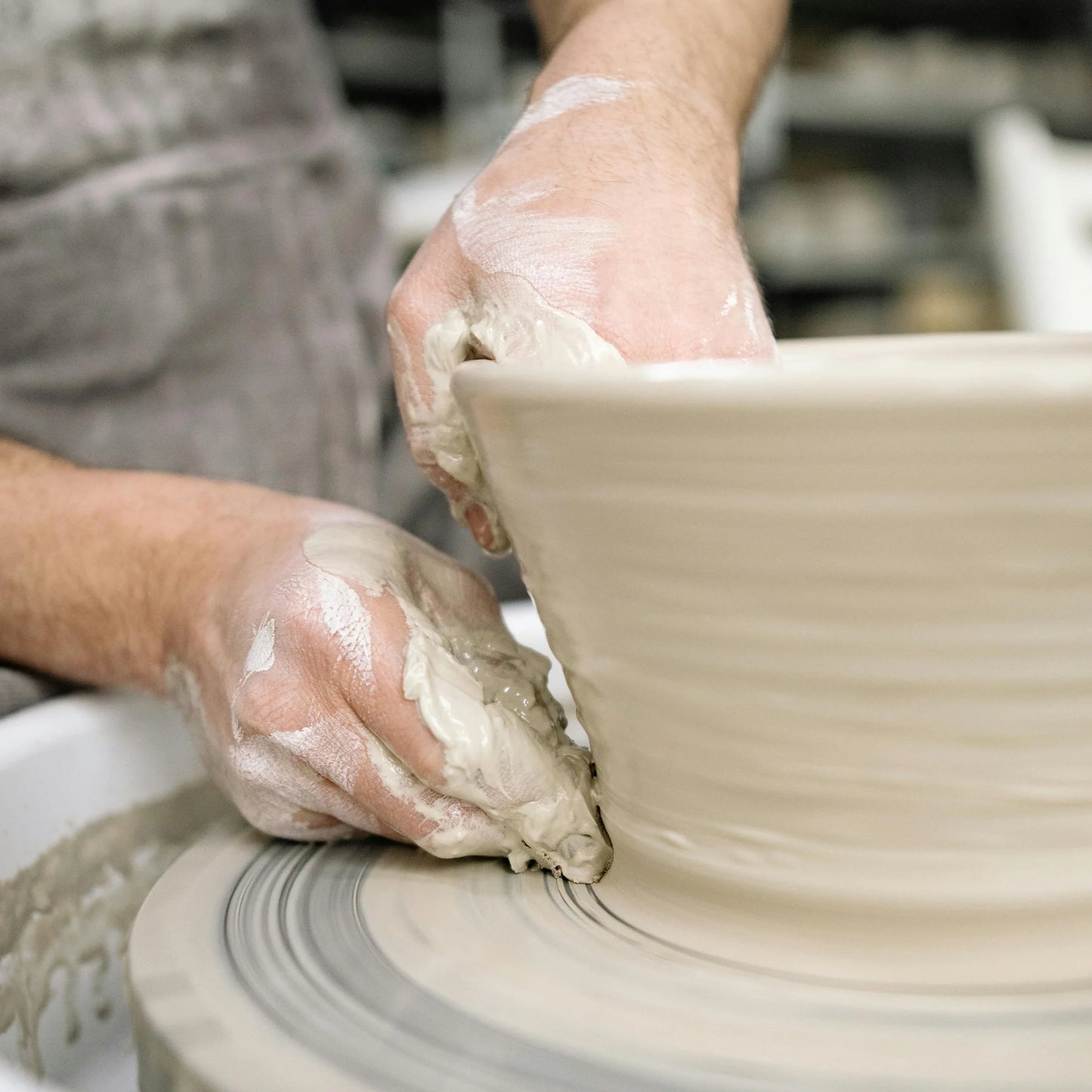 a student throws a bowl during beginners pottery class at Claya pottery studio in Denver, Colorado