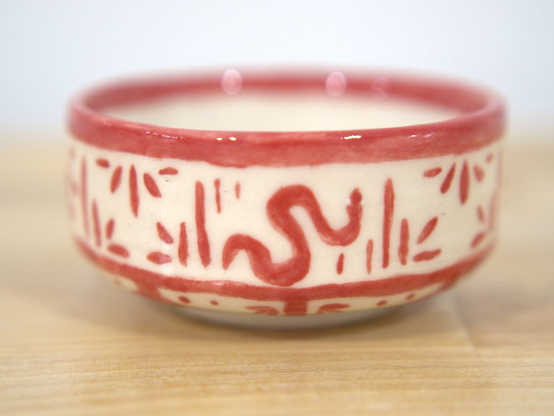 Red hand-painted ceramic bowl made at Claya pottery studio in Denver