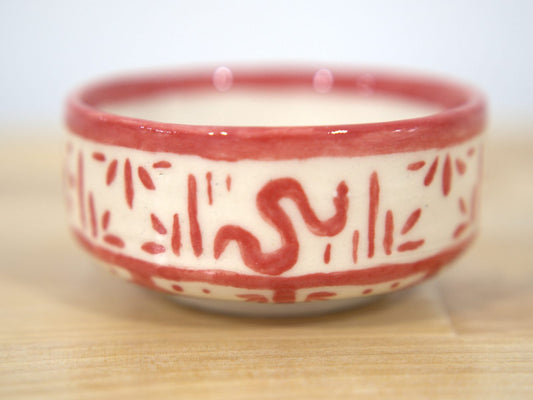 Red hand-painted ceramic bowl made at Claya pottery studio in Denver