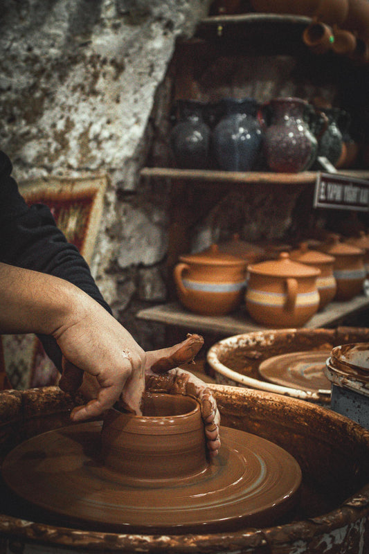 Pottery artisan shaping clay on a wheel
