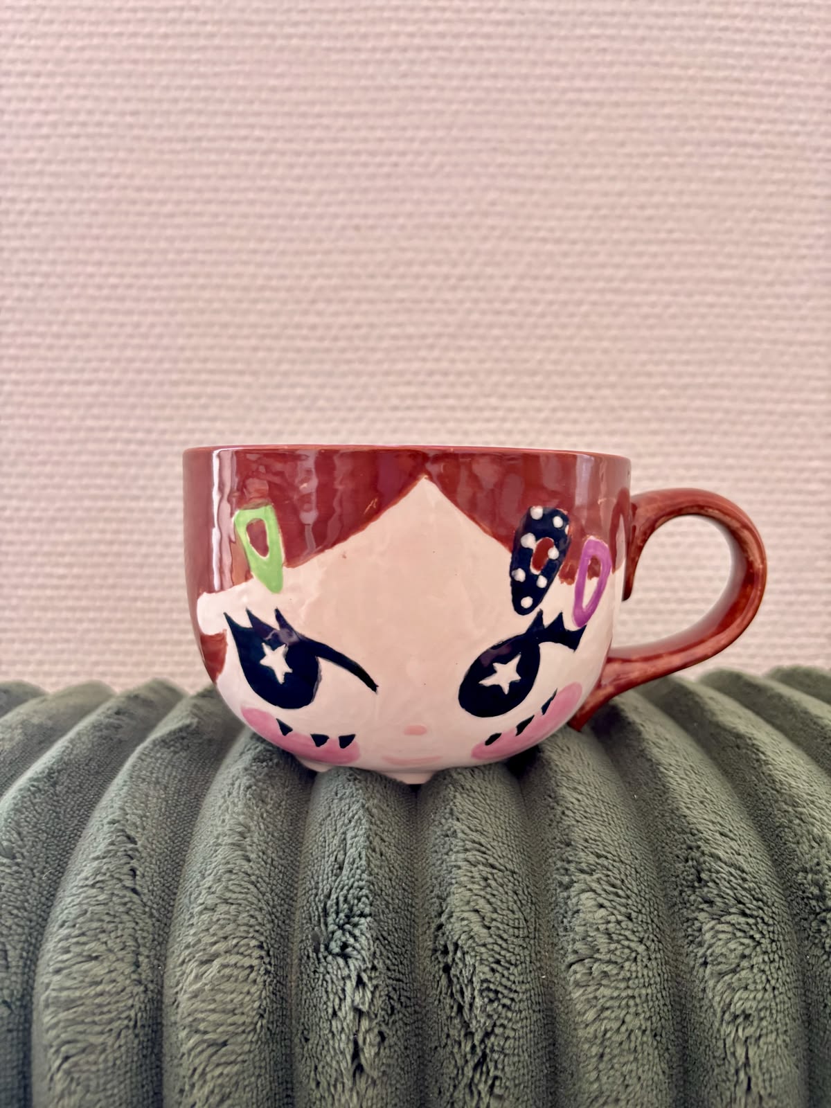 Face mug painted with underglaze, star eyes and hair clips