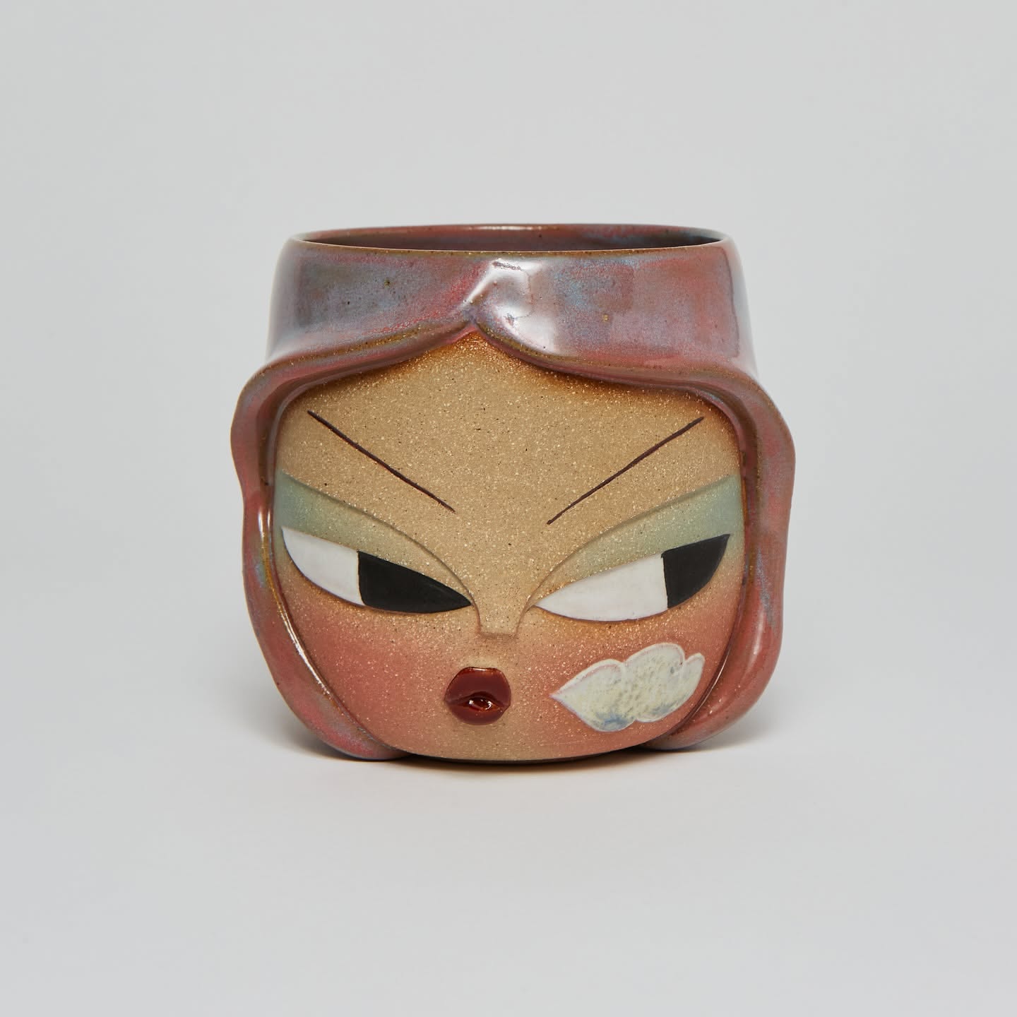 Carved face mug with copper flashing glaze