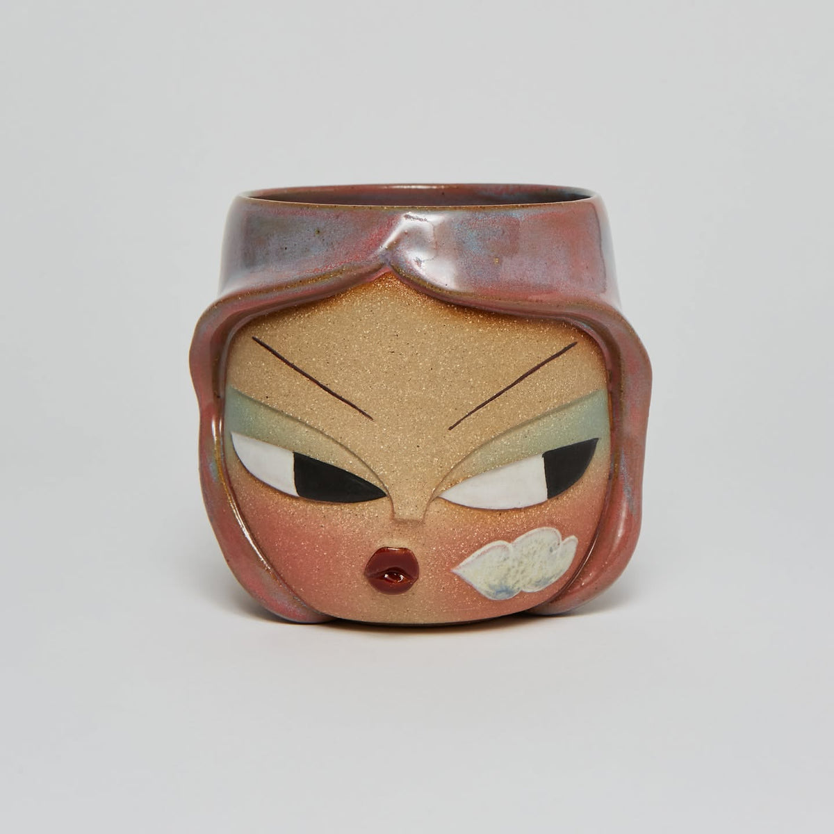 Carved face mug with copper flashing glaze