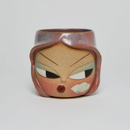 Carved face mug with copper flashing glaze
