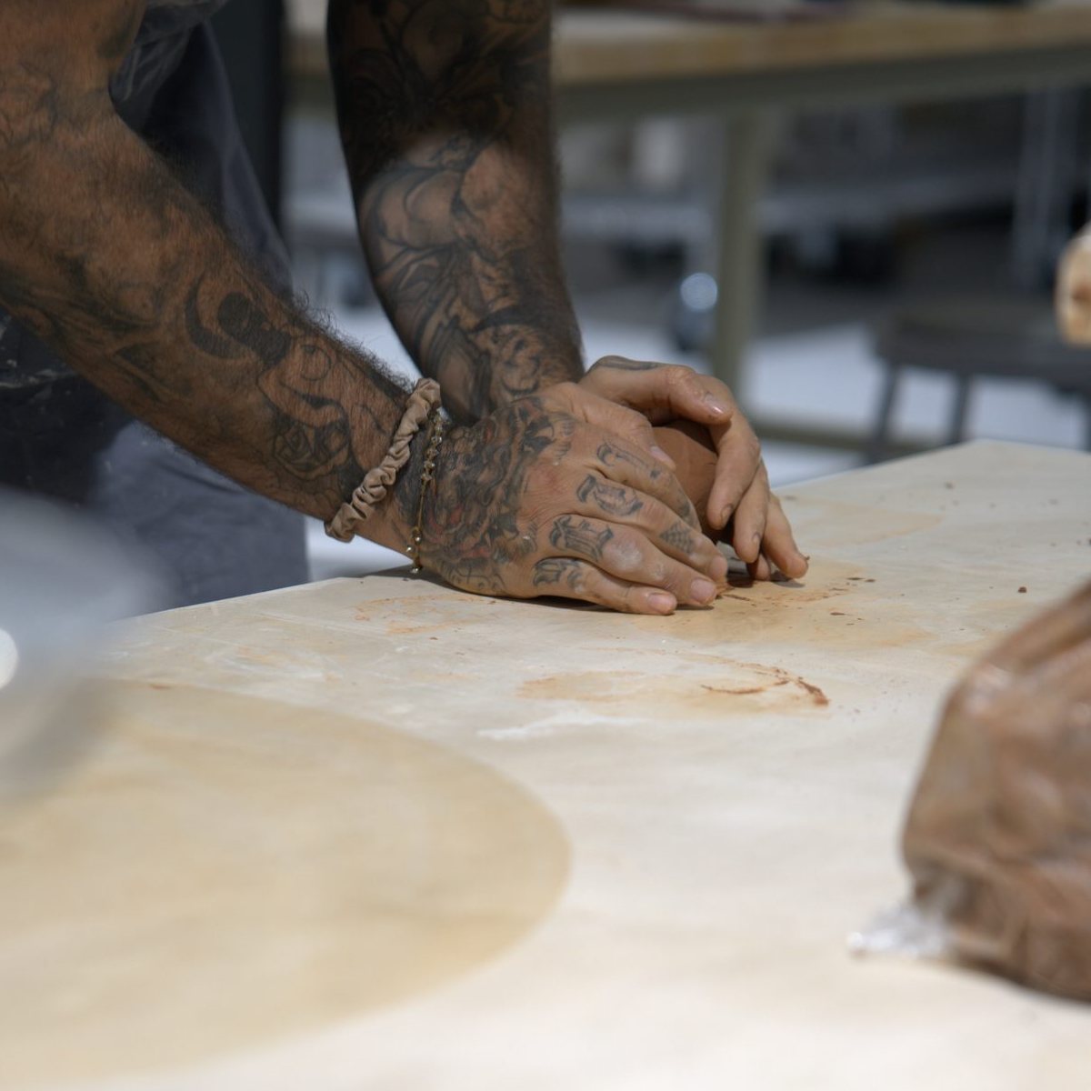 Wedging clay at Claya pottery studio in RiNo, Denver