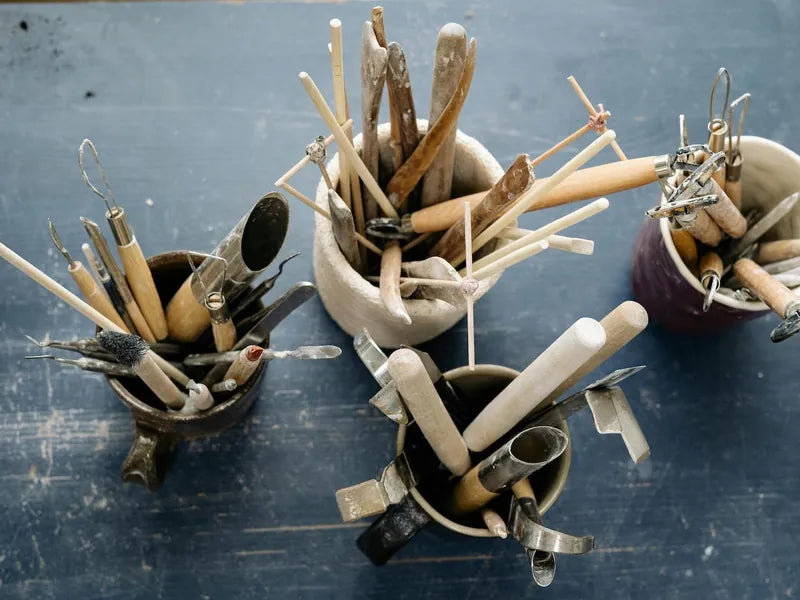 Assorted pottery tools arranged in studio cups at CLAYA’s Denver location