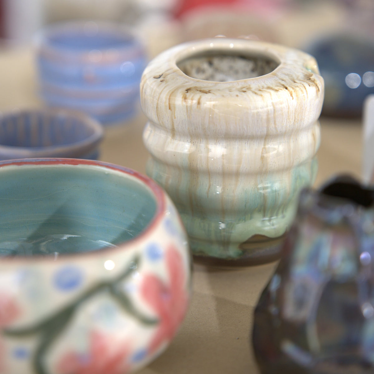Glazed bowls and vases made by students at Claya Studios in RiNo, Denver