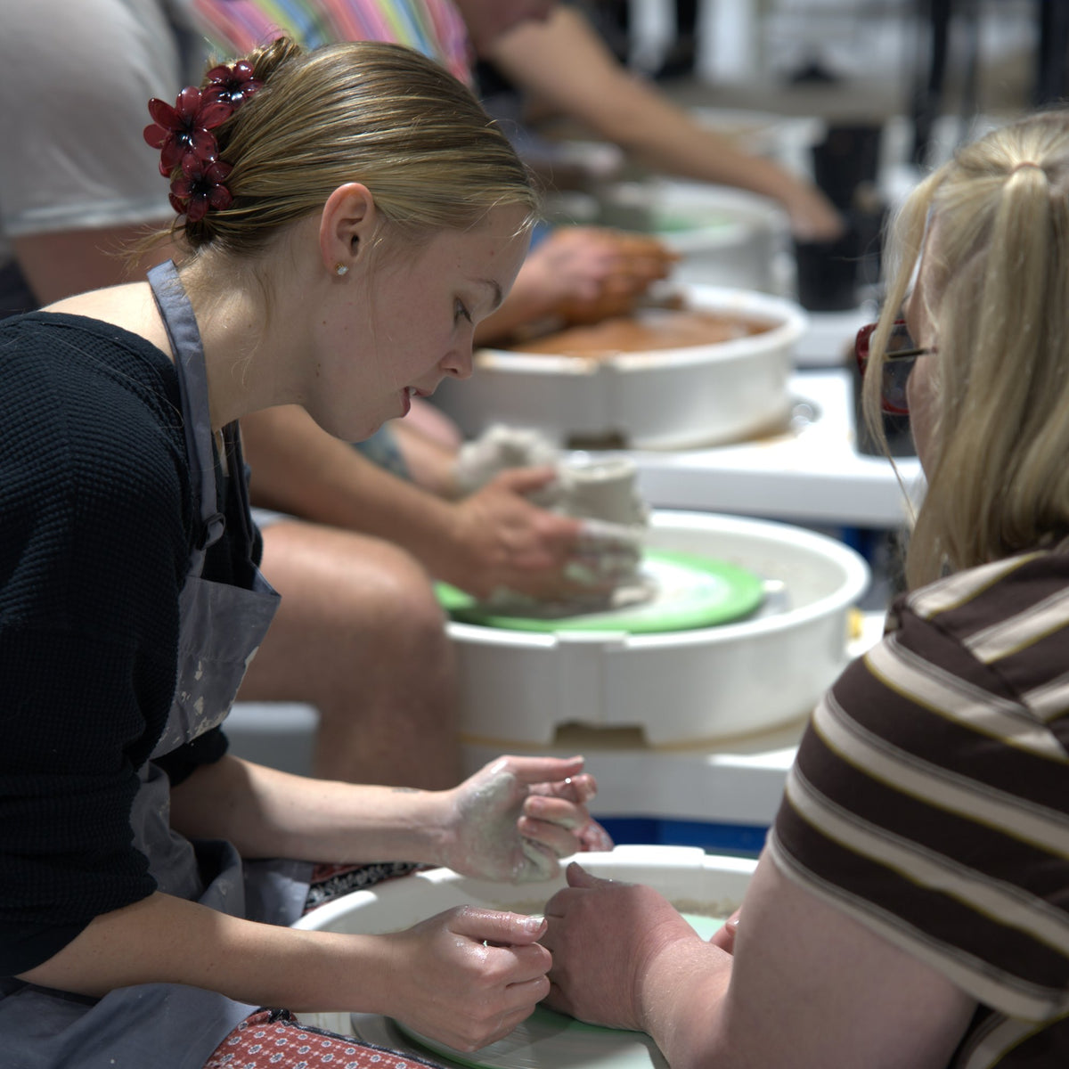 Student throwing on the pottery wheel at a Try the Wheel class at Claya Studios in RiNo, Denver