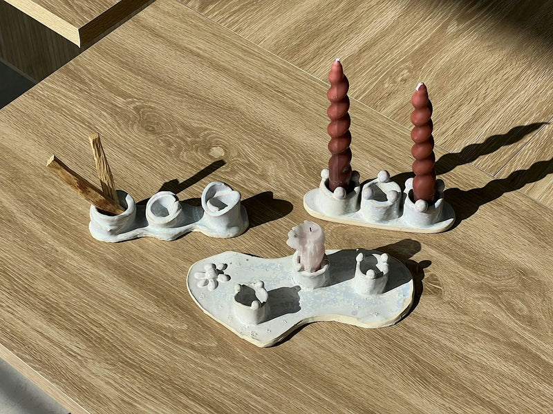 Three handbuilt ceramic candlestick holder sets with taper candles, made in a one-night handbuilding workshop at Claya in Denver