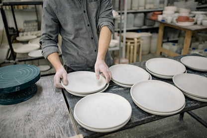 Finished handbuilt pottery pieces stacked at Claya pottery studio in Denver's RiNo district
